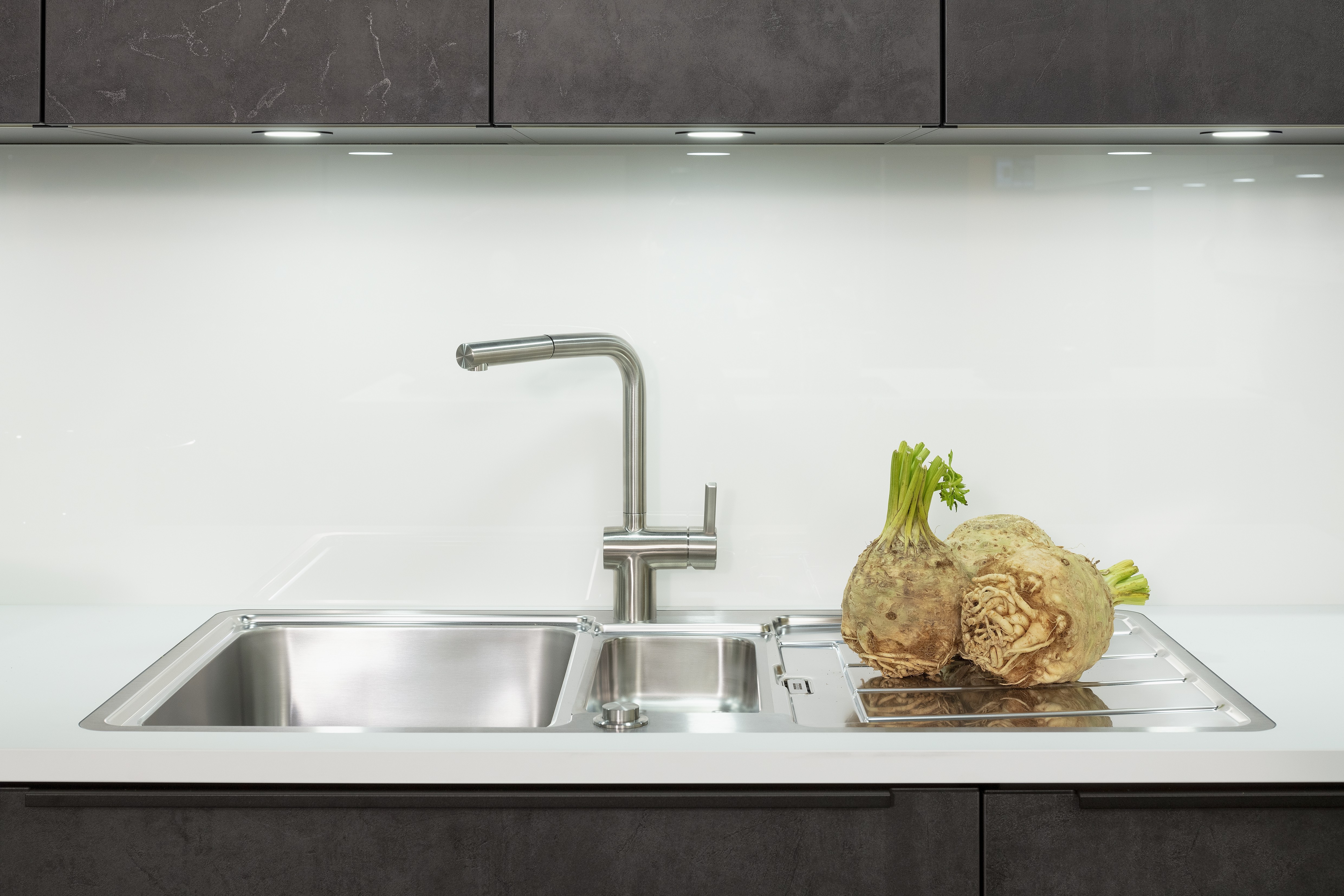 Concept130 Front: Comet Spachtelbeton schwarz Kunststoff strukturiert Murano Bril Kristallweiss Designglas eingefasst APL: Kristallweiß Perfect Sense 25 mm Geräte Blaupunkt Spüle und Armatur: Franke  Features: Dachschräge, Maßeinbau, Sideboard, offene Regale mit Downlights.